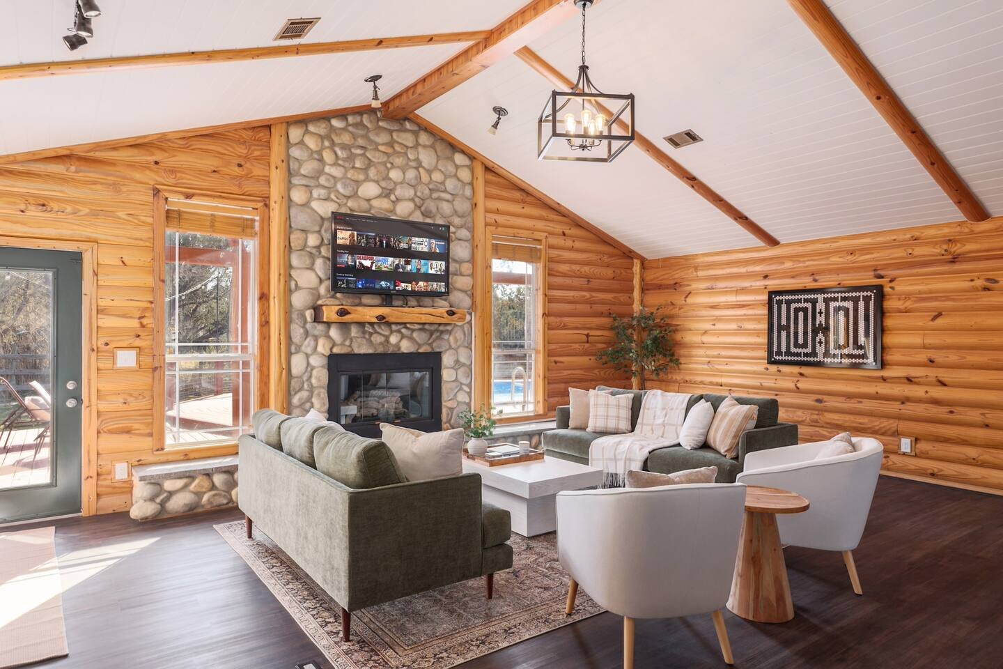 Fitzhugh Lodge log cabin living room with stone fireplace