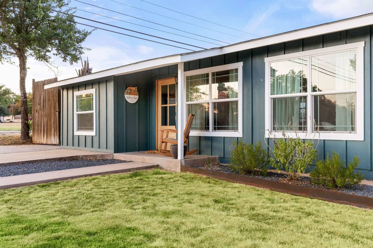 Mulberry House · Blue board-and-batten cottage with a green front lawn